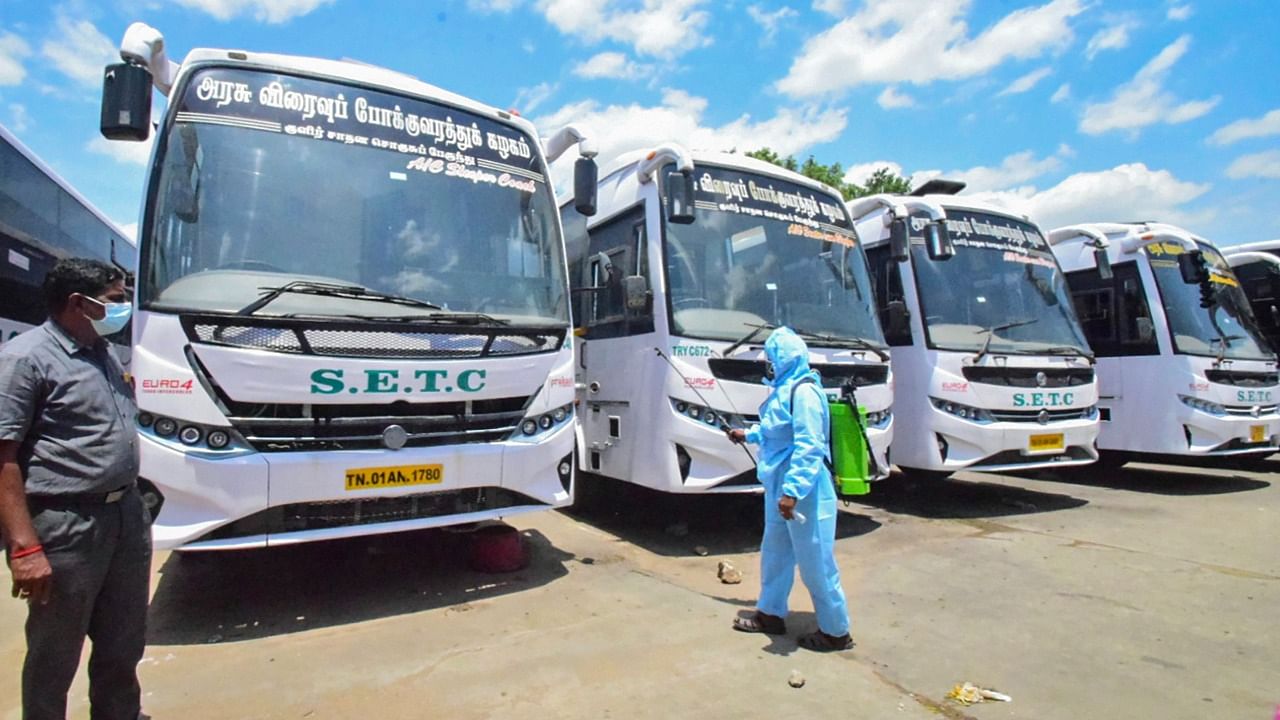 A worker sanitises AC buses ahead of resumption of their operations. Credit: PTI Photo