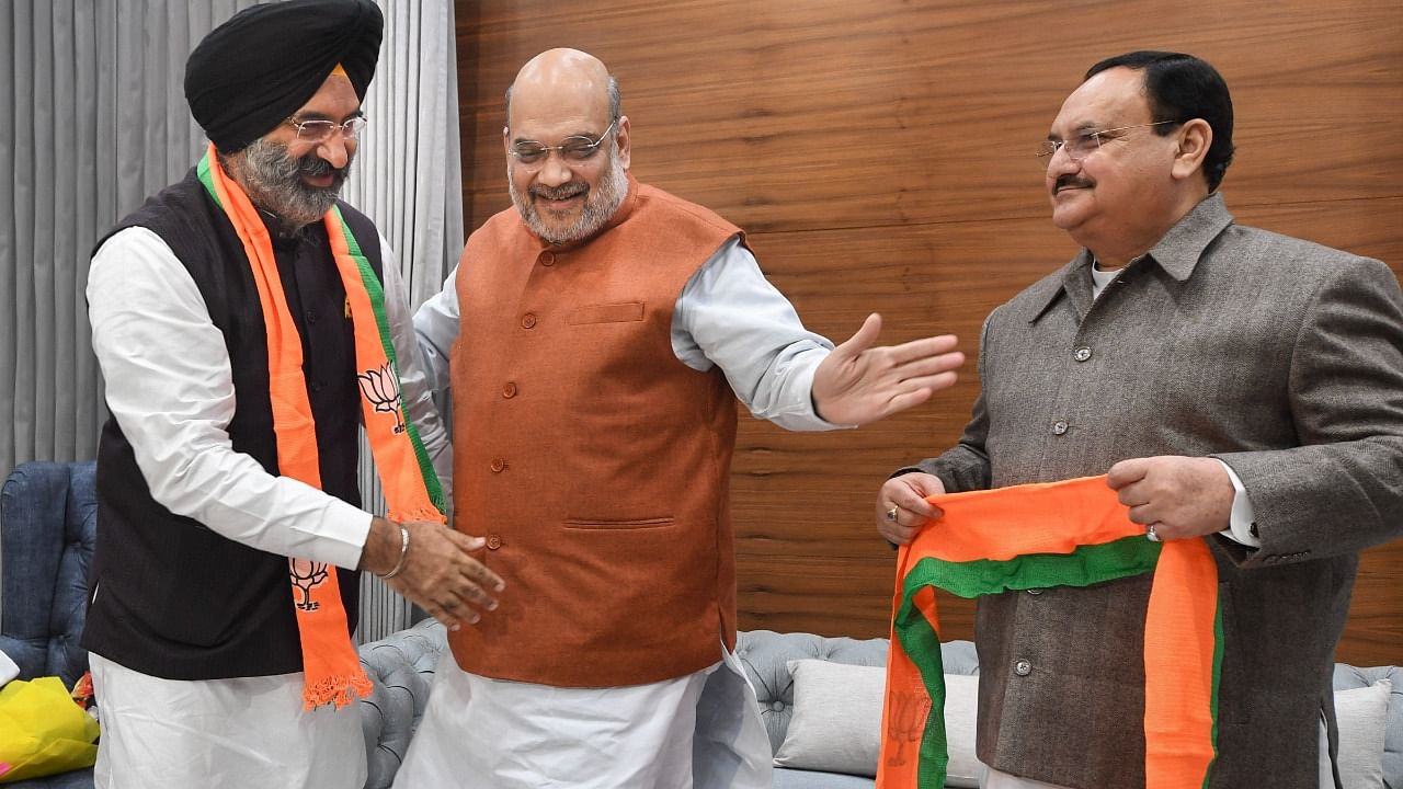 Shiromani Akali Dal leader Manjinder Singh Sirsa joins BJP in the presence of Home Minister Amit Shah and BJP President J P Nadda, at the party headquarters in New Delhi. Credit: PTI Photo