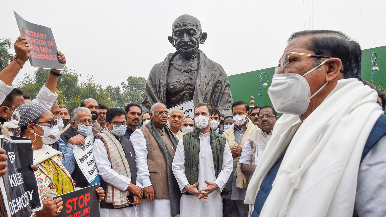  Congress MP Rahul Gandhi and other leaders during a protest over suspension of 12 Rajya Sabha MPs, near the Mahatma Gandhi's statue at Parliament, in New Delhi. Credit: PTI Photo
