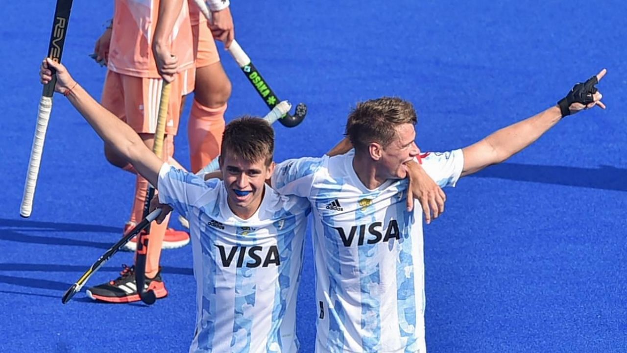 Argentine player Joaquin Kruger (R) jubilate with teammate Igancio Ibarra after scoring first goal against Netherlands. Credit: PTI Photo