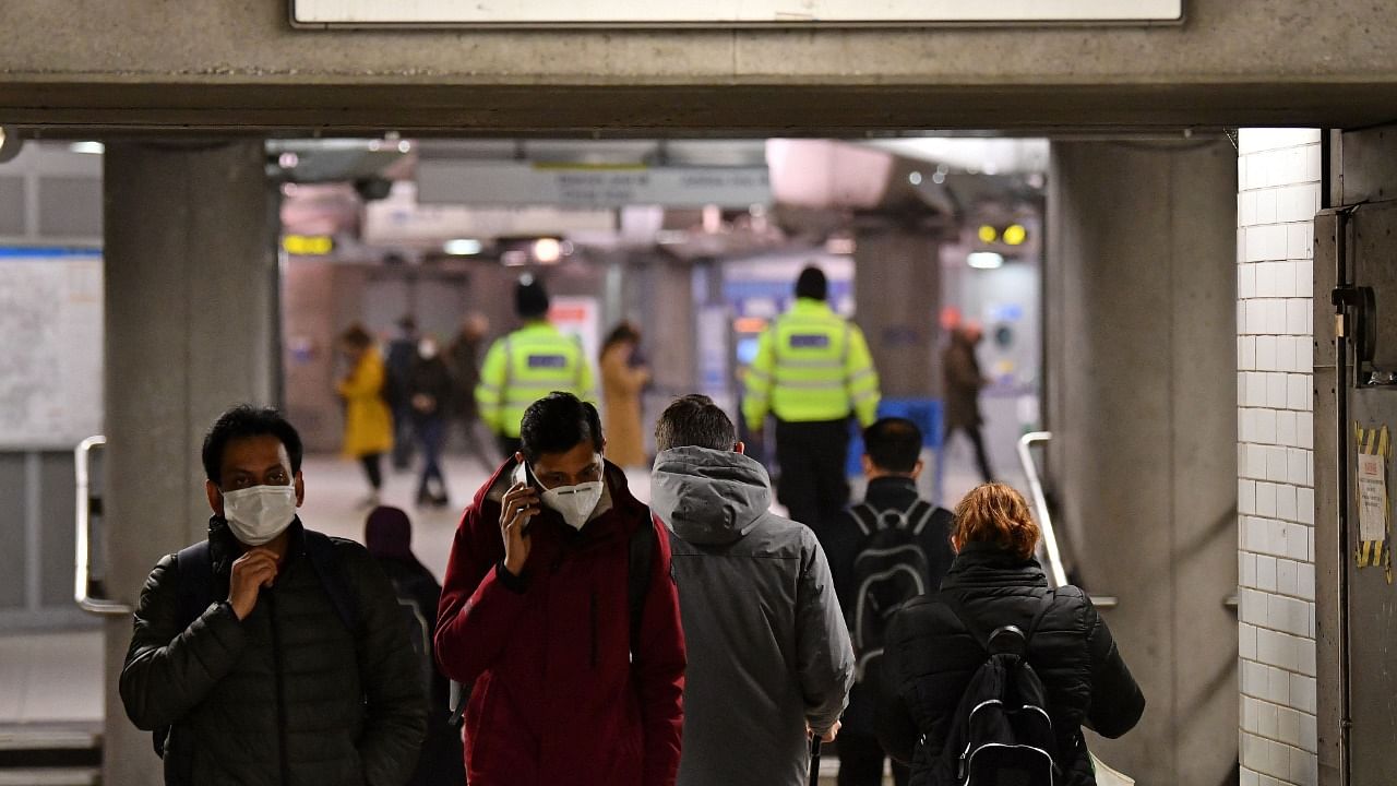 Britain will require all arriving passengers to isolate until they can show a negative PCR test against Covid-19 and is restoring a mandate to wear face masks in shops and public transport as part of its response to the new Omicron strain of Covid-19. Credit: AFP Photo