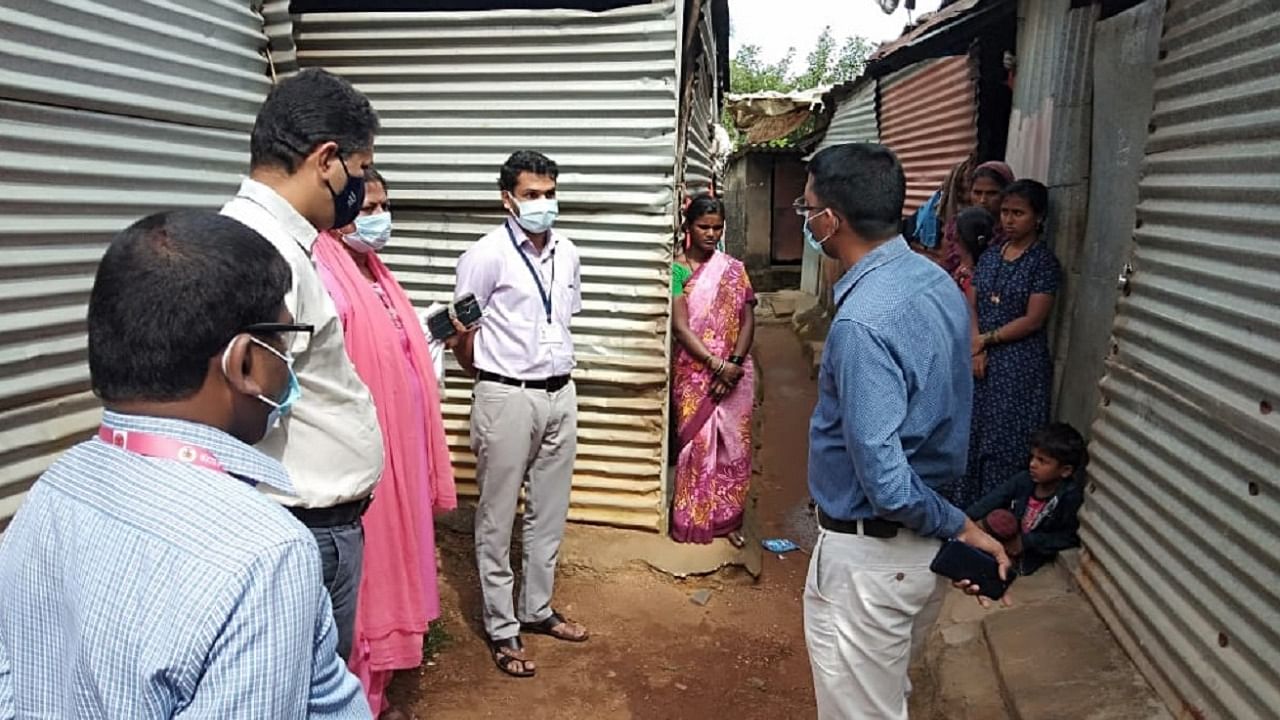 Deputy Commissioner M Kurma Rao interacts with labourers at Beedinagudde in Udupi. Credit: DH photo