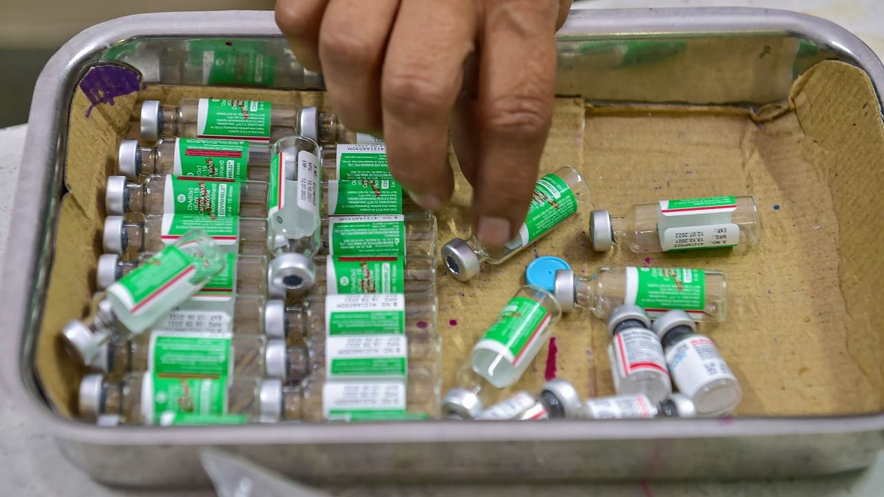 A medic sorts the vials of Covid-19 vaccine at a government vaccination centre in Bengaluru. Credit: PTI Photo