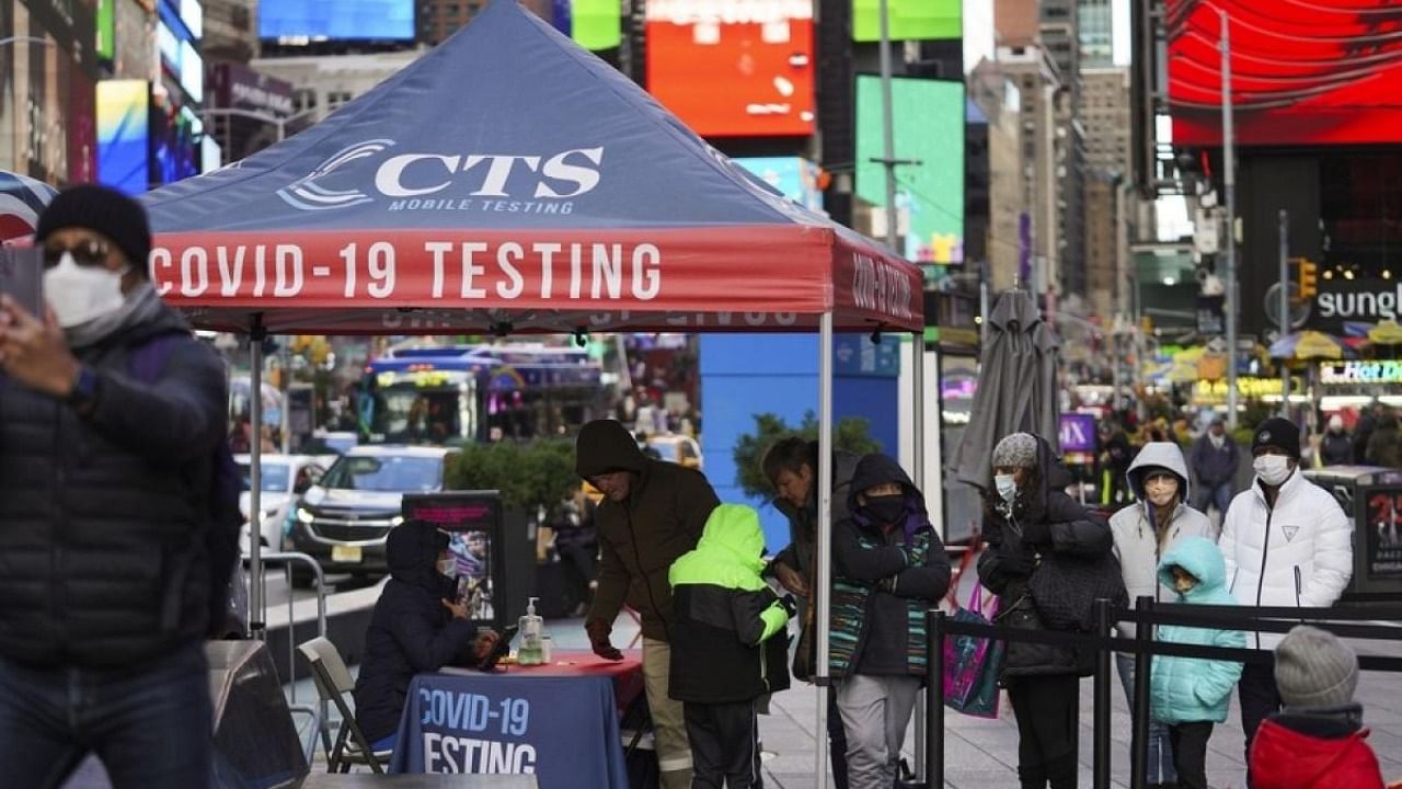 People wait for Covid-19 tests on Times Square in New York, the United States. Credit: IANS Photo