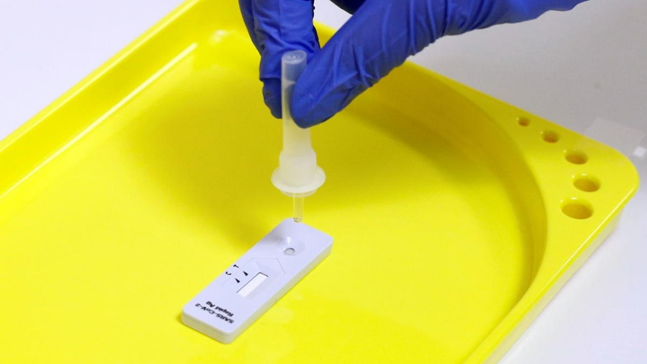  A staff member processes a rapid Covid-19 antigenic test made by Swiss drugmaker Roche. Credit: Reuters File Photo