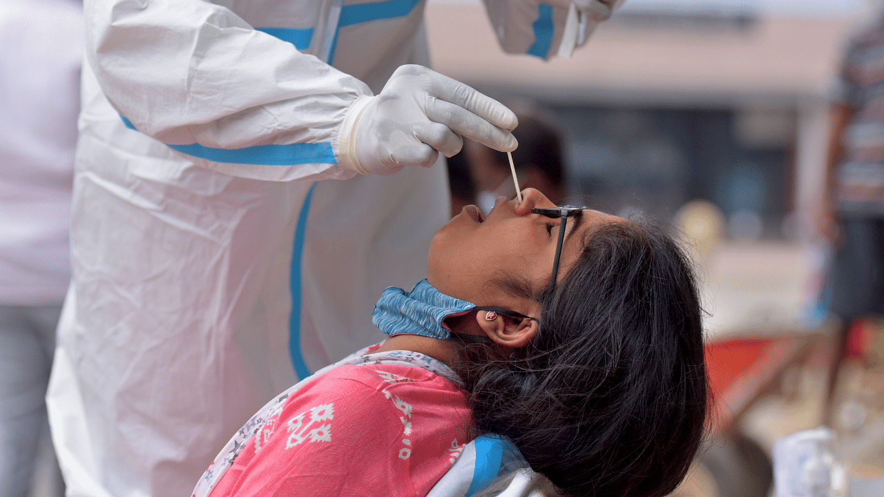 A healthcare worker collects swab samples for coronavirus. Credit: DH Photo