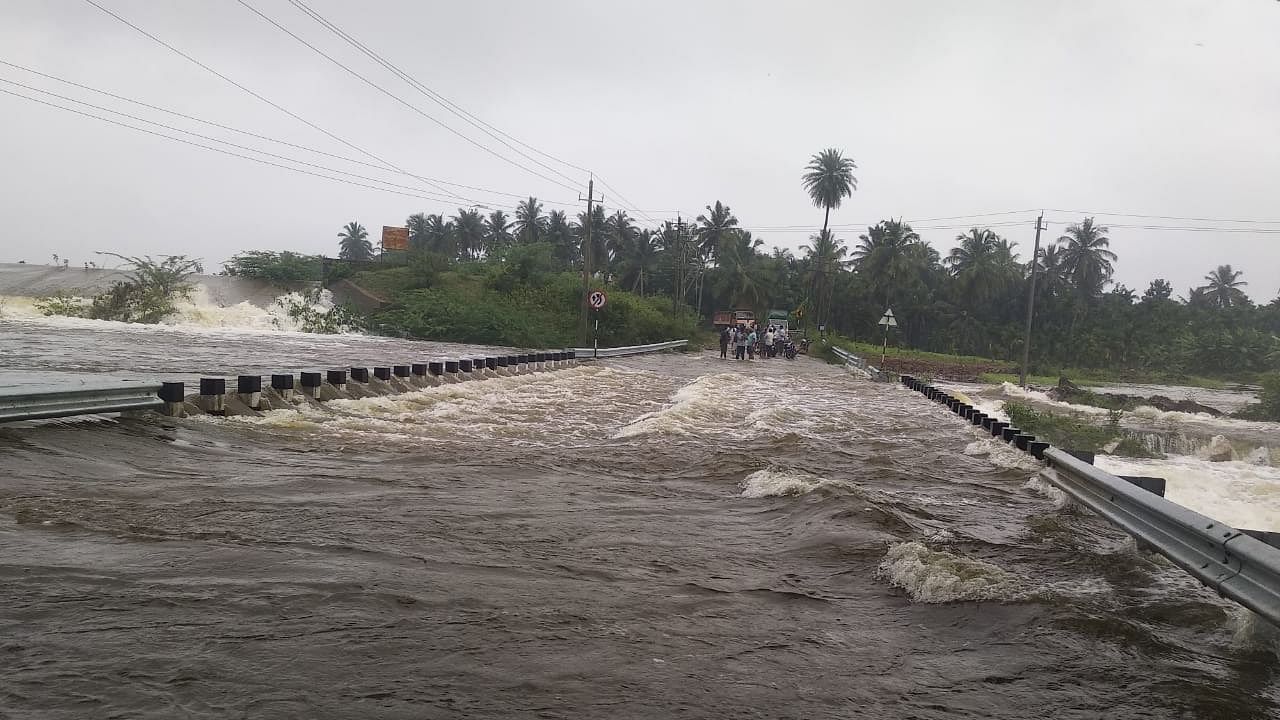 Following rain, water from Shivani lake started flowing over the bridge. Credit: DH Photo