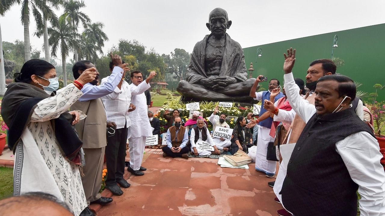 Opposition parties' MPs protest over suspension of 12 Rajya Sabha MP's during the Winter Session of Parliament, in New Delhi. Credit: PTI Photo