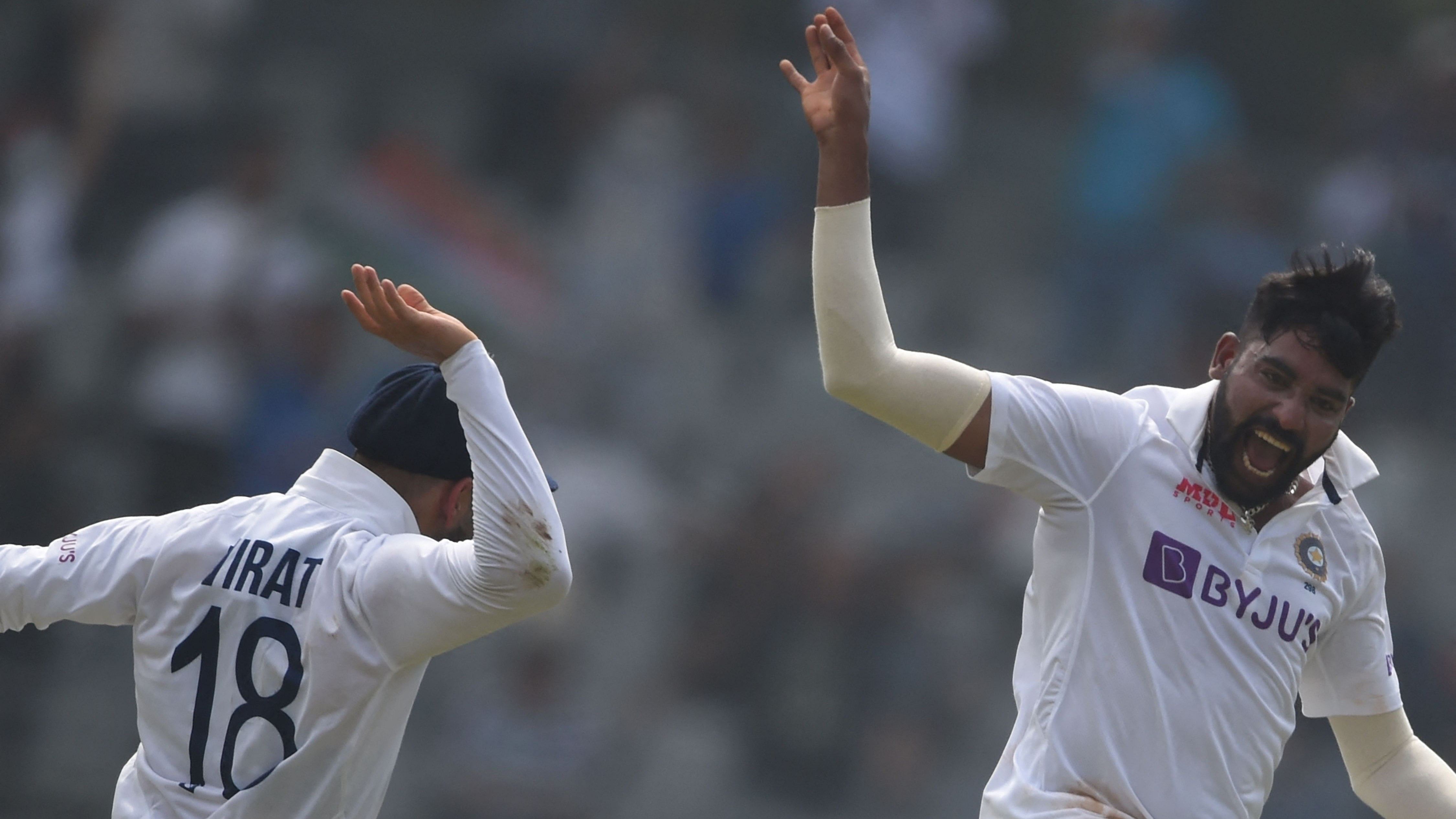 Mohammed Siraj (R) celebrates after the dismissal of New Zealand's captain Tom Latham. Credit: AFP Photo