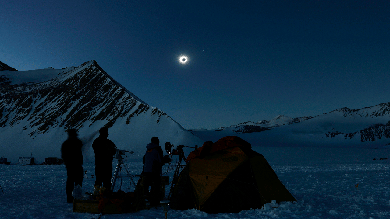 Chilean and US scientists looking at a solar eclipse from the Union Glacier in Antarctica. Credit: AFP Photo