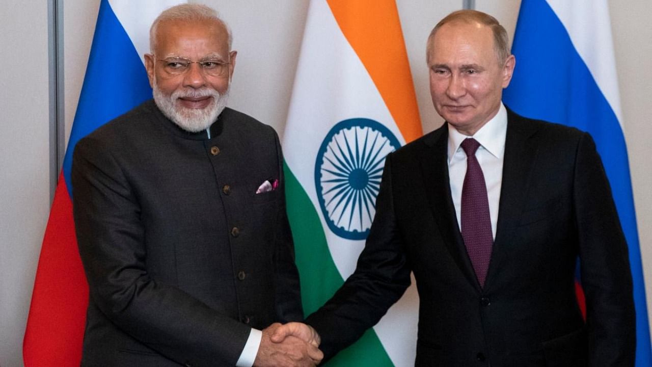 Russian President Vladimir Putin (R) and Indian Prime Minister Narendra Modi shake hands during their meeting on the sidelines of the 11th edition of the BRICS Summit. Credit: AFP photo