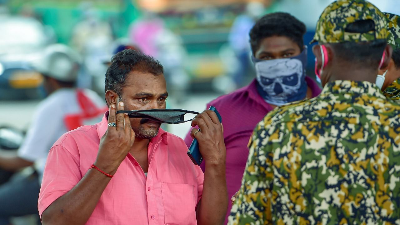 Bruhat Bengaluru Mahanagara Palike (BBMP) marshals ask citizens to wear a mask amid fear of spread of a new variant. Credit: PTI File Photo
