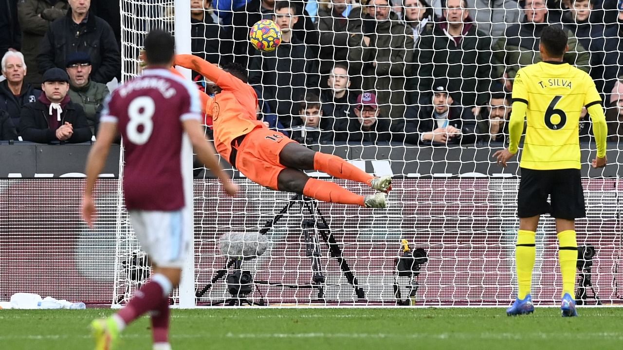 West Ham United's French defender Arthur Masuaku (unseen) scores his team's third goal past Chelsea's French-born Senegalese goalkeeper Edouard Mendy (C) during the English Premier League football match between West Ham United and Chelsea at The London Stadium, in east London on December 4, 2021. Credit: AFP Photo