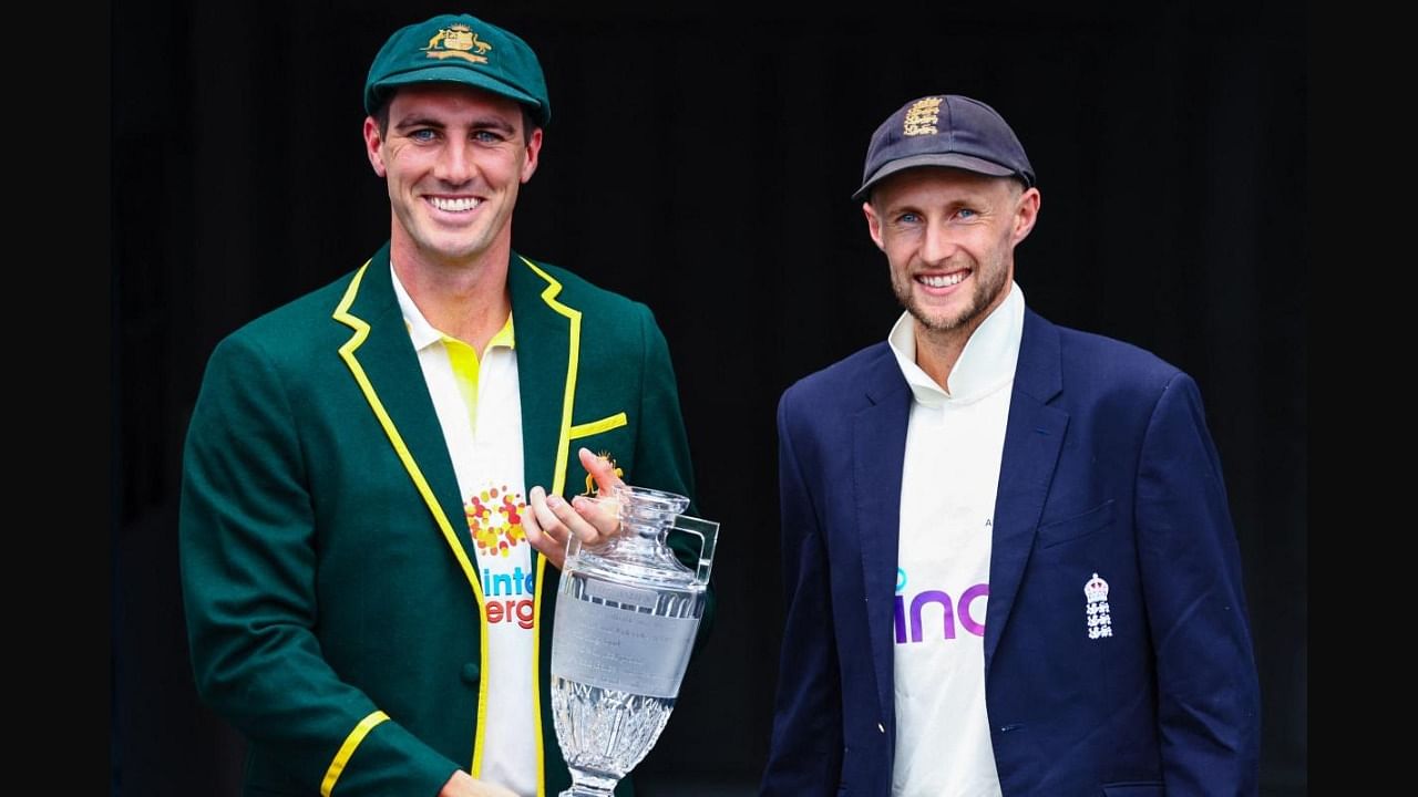 Australia's new captain Patrick Cummins (L) and England's captain Joe Root (R) pose with the Ashes trophy at the Gabba in Brisbane. Credit: AFP Photo