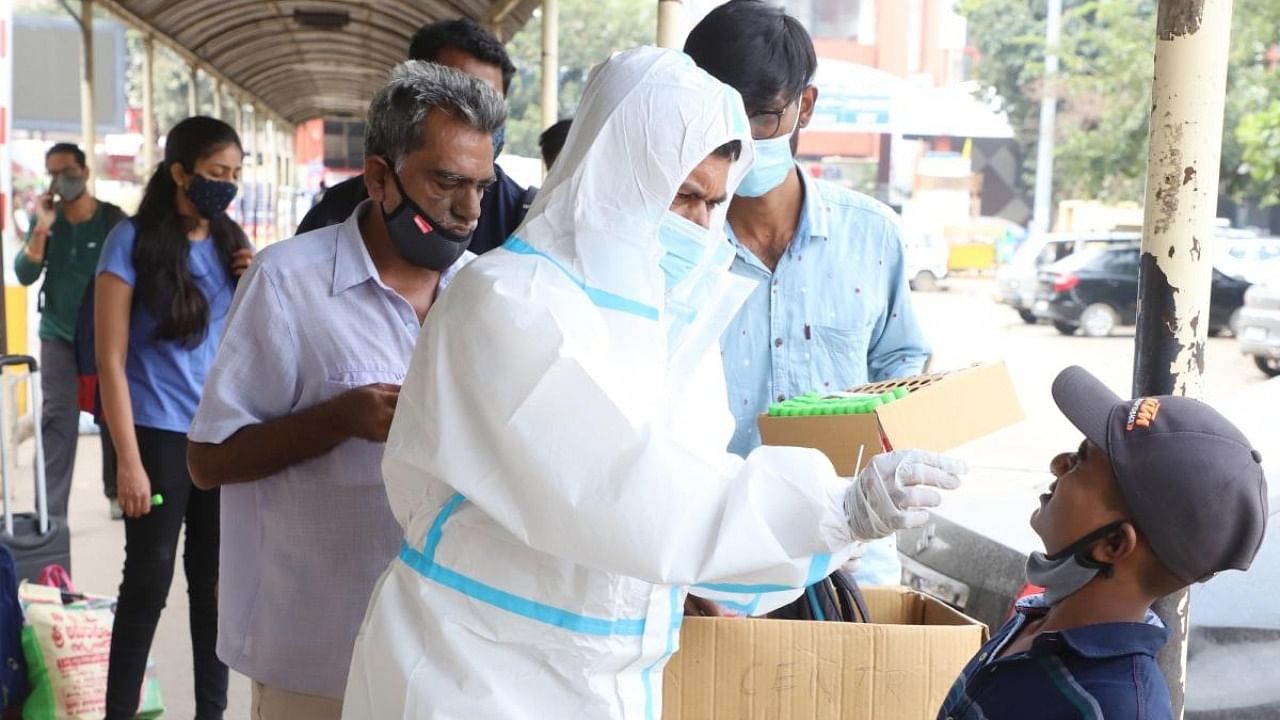 Health care worker collects sample to check for Covid-19 in Bengaluru. Credit: IANS Photo