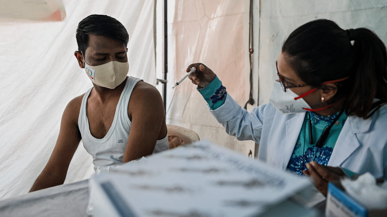 A man gets himself inoculated with the Covisheild coronavirus vaccine. Credit: AFP Photo