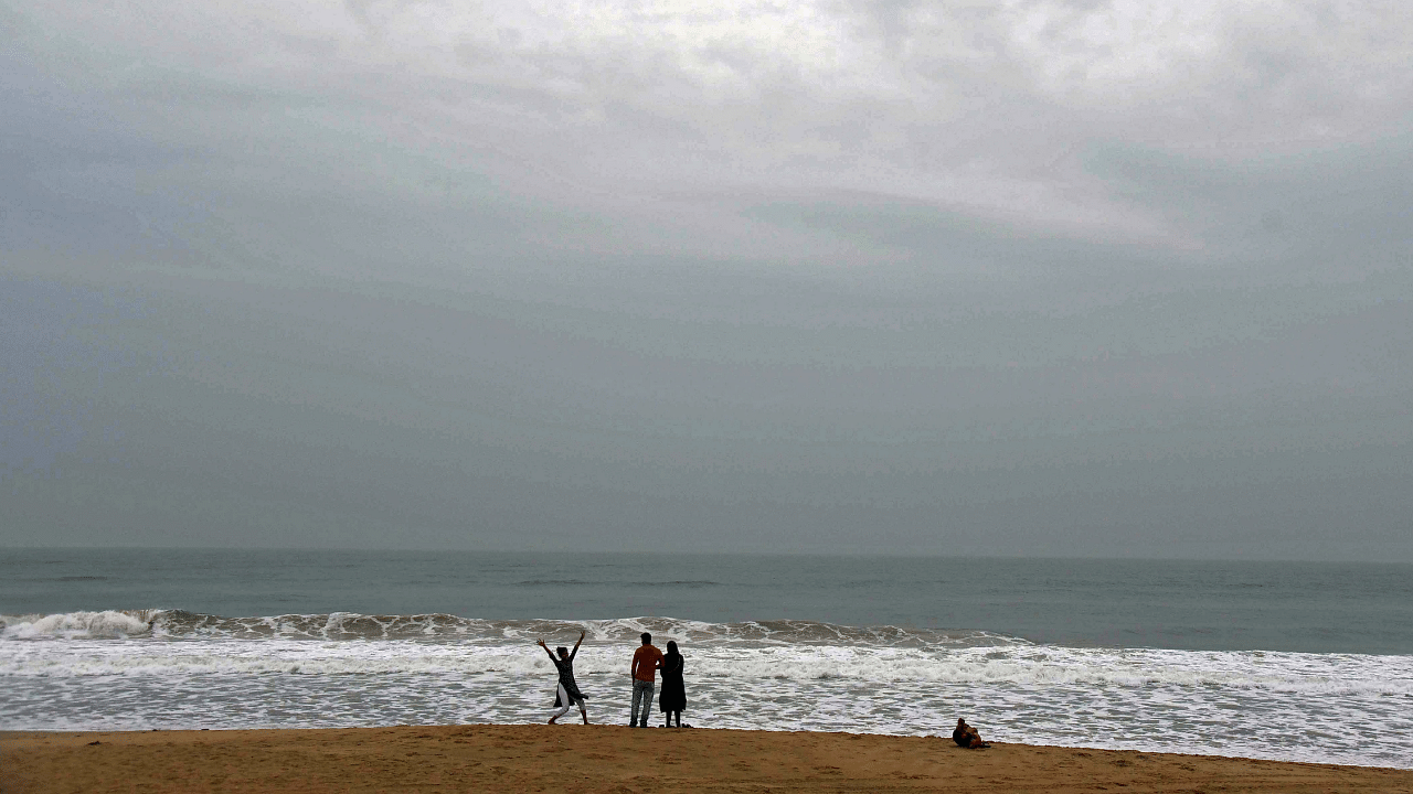 People visit the deserted Chandrabhaga sea beach, amid Cyclone Jawad threat in Puri. Credit: PTI Photo