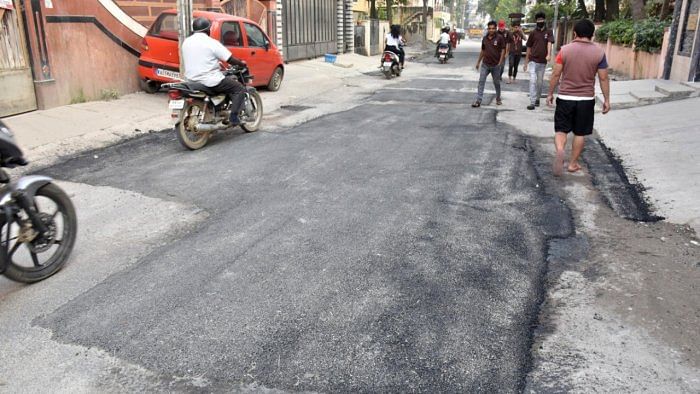 Following a protest by the Bharathinagar Residents Forum on Sunday, the BBMP undertook road patchworks along Charles Campbell Road at Cox Town on Thursday. Credit: DH Photo/B K Janardhan