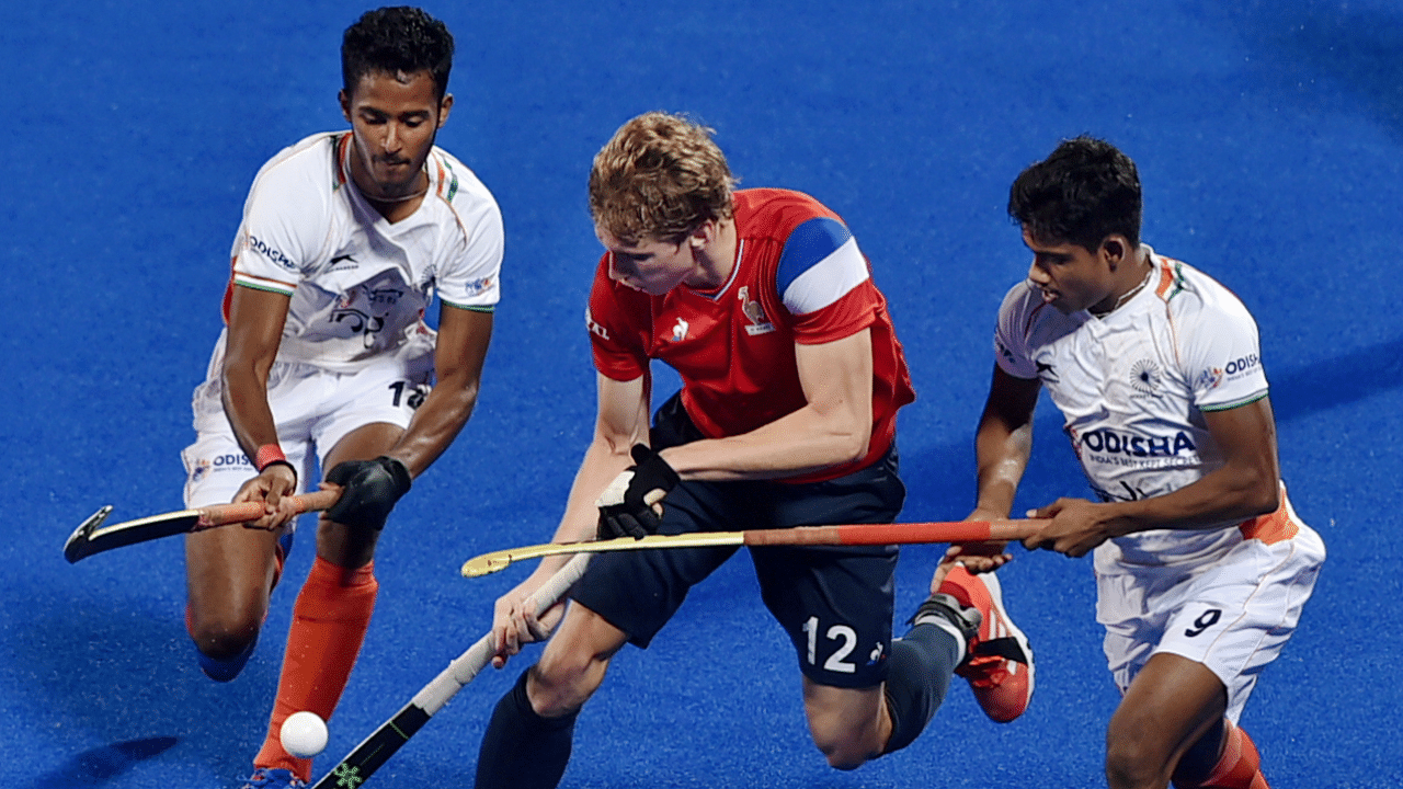 Indian (white) and French players vie for the ball during the 3rd-4th place ranking match at FIH Odisha Hockey Men's Junior World cup 2021. Credit: PTI Photo
