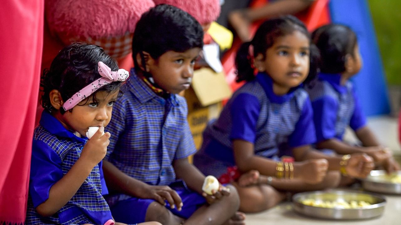 Children eat their mid-day meal at an Integrated Child Development Services (ICDS) centre, after its reopenin, in Gill Nagar, Choolaimedu, in Chennai. Credit: PTI Photo