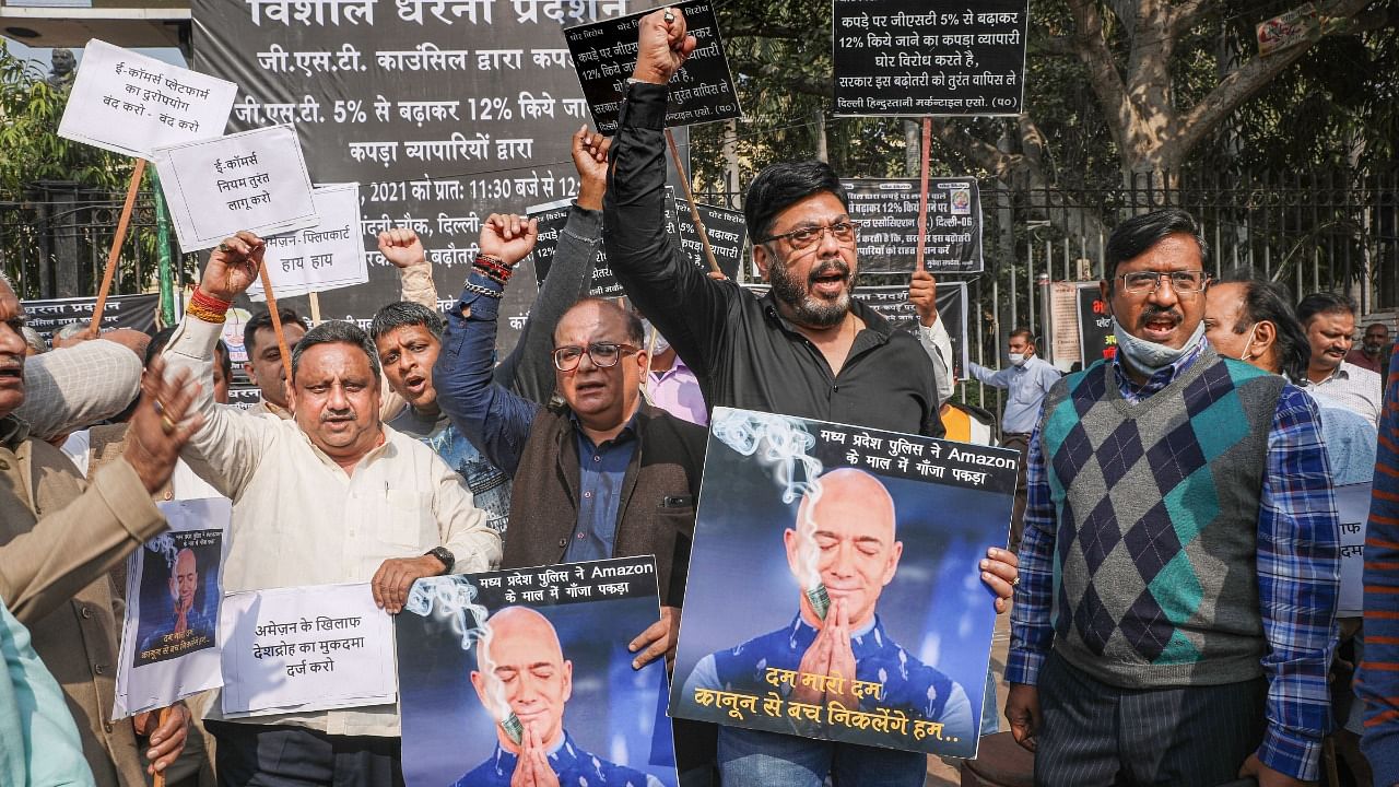 In a recent protest against GST, traders display a poster of Amazon's founder Jeff Bezos in reference to the drug racket. Credit: PTI Photo