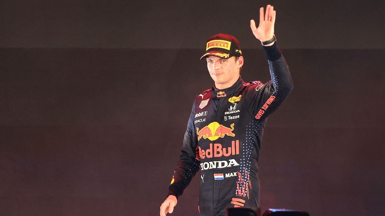 Second-placed Red Bull's Dutch driver Max Verstappen waves during the podium ceremony after the Formula One Saudi Arabian Grand Prix at the Jeddah Corniche Circuit in Jeddah on December 5, 2021. Credit: AFP Photo