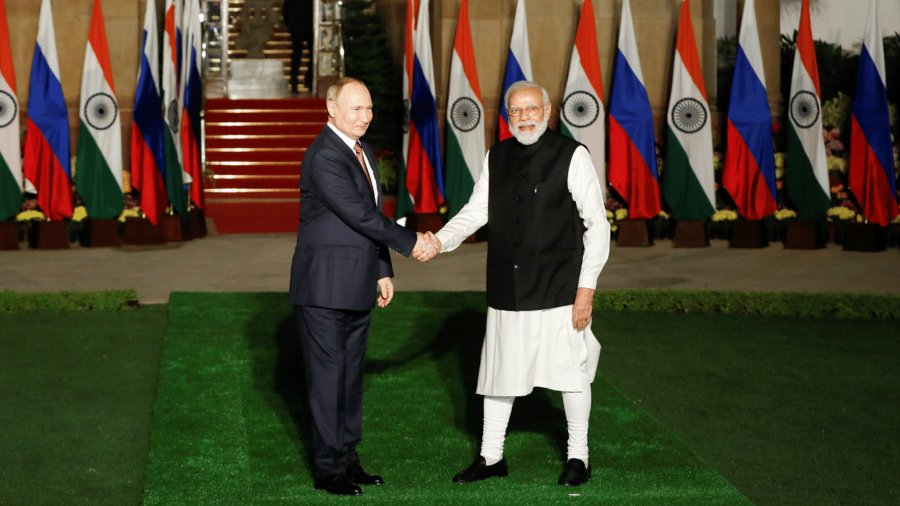Russia's President Vladimir Putin shakes hands with India's Prime Minister Narendra Modi ahead of their meeting at Hyderabad House. Credit: Reuters Photo