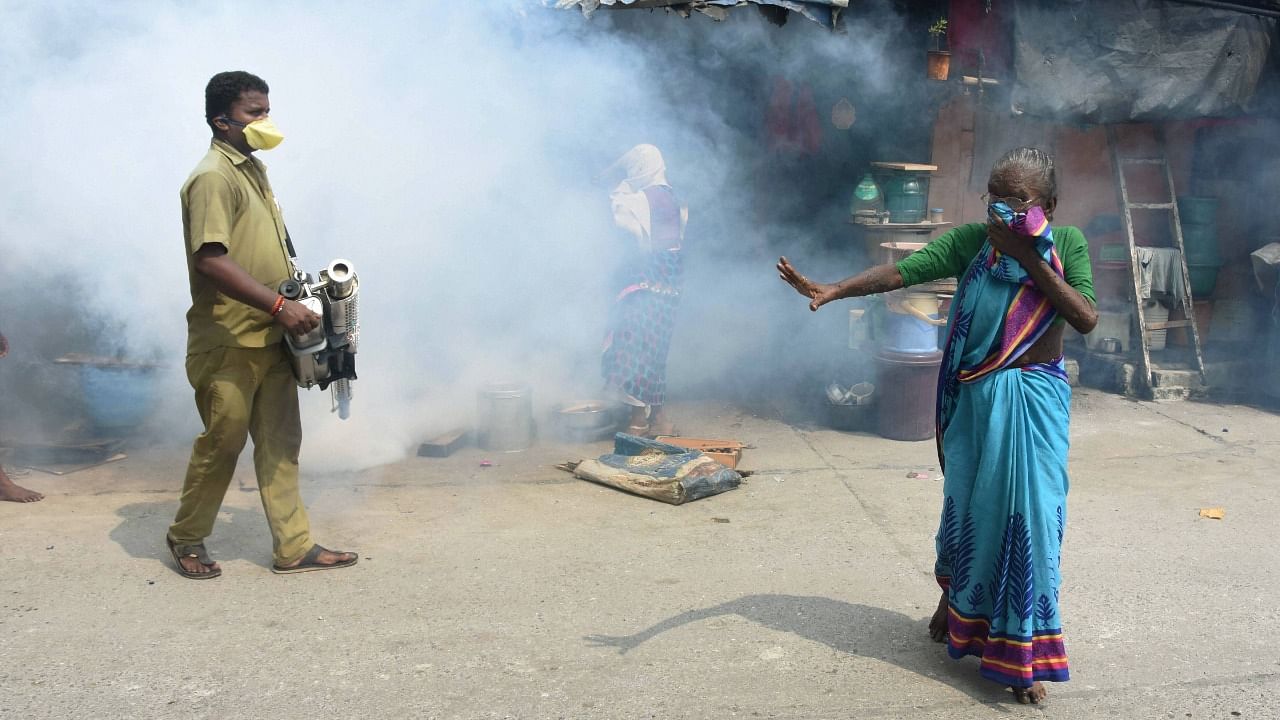 An Indian government worker undertakes fumigation to stop mosquito breeding. Credit: PTI File Photo