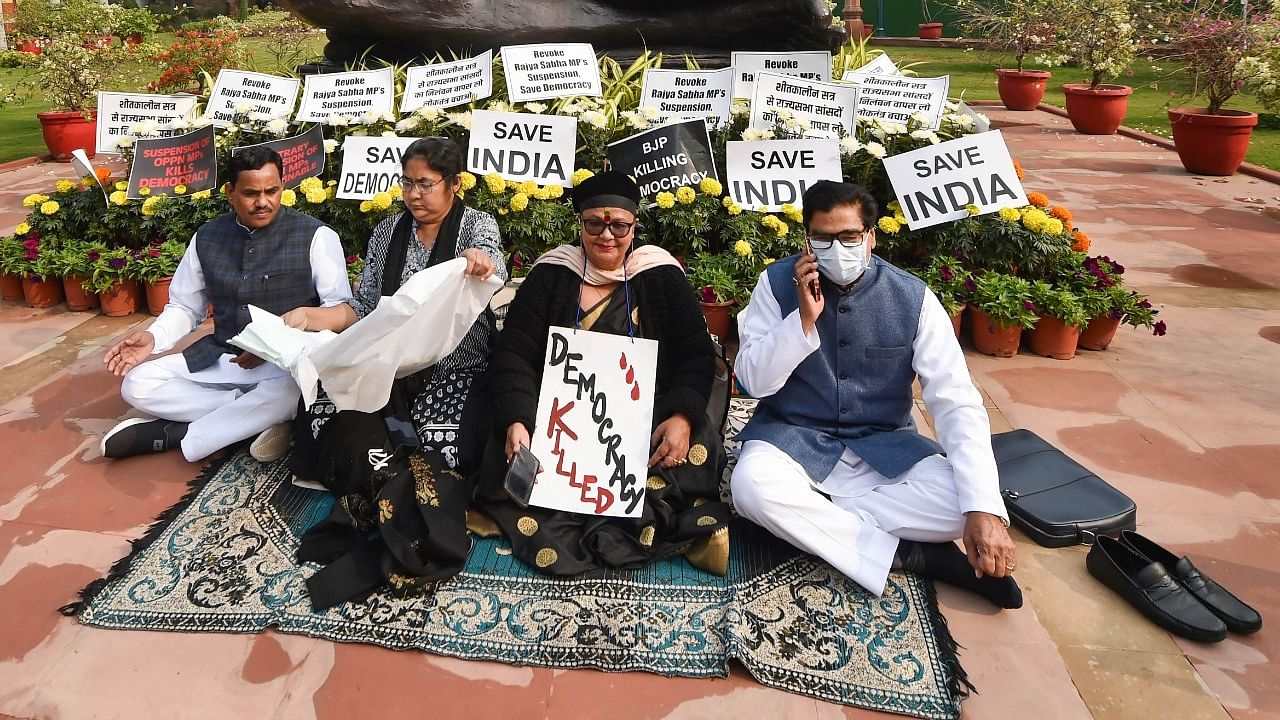 Suspended MPs have been protesting near the Gandhi statue in Parliament. Credit: PTI Photo