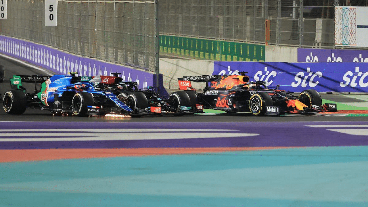 Red Bull's Dutch driver Max Verstappen (R), Mercedes' British driver Lewis Hamilton (C) and Alpine's French driver Esteban Ocon (L) compete in the Formula One Saudi Arabian Grand Prix. Credit: AFP Photo