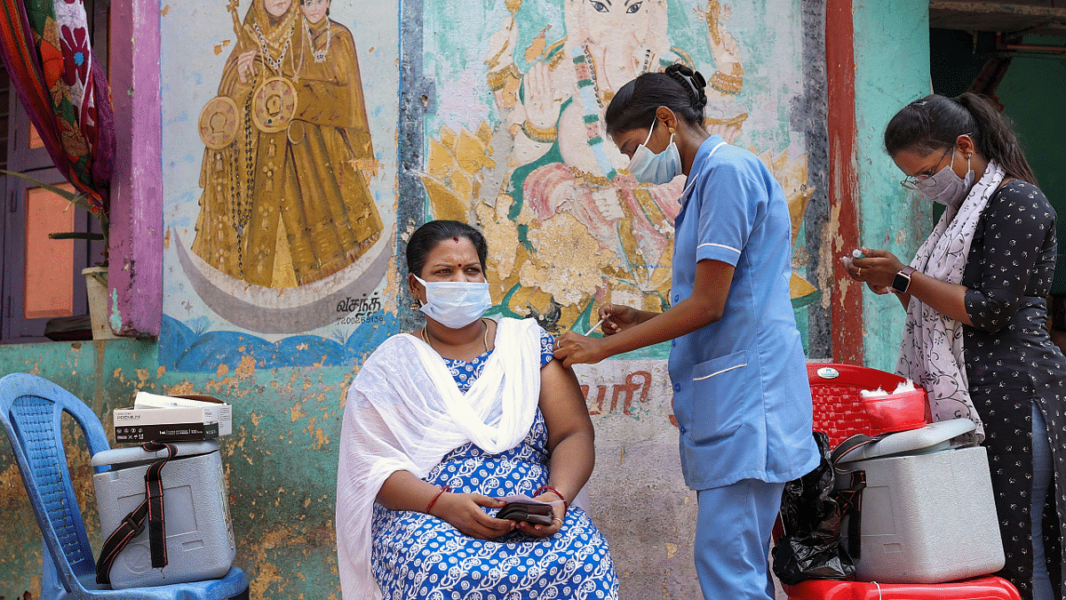 A health worker inoculates a beneficiary with the dose of Covishield vaccine against the coronavirus. Credit: PTI Photo