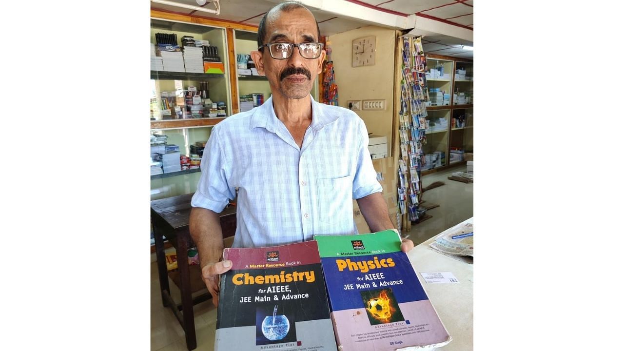 G Madhav Prabhu, the owner of a book shop in Koormadka in Puttur, with books donated by people that will be given to the poor to help them crack AIEEE, JEE and other competitive examinations. Credit: DH Photo