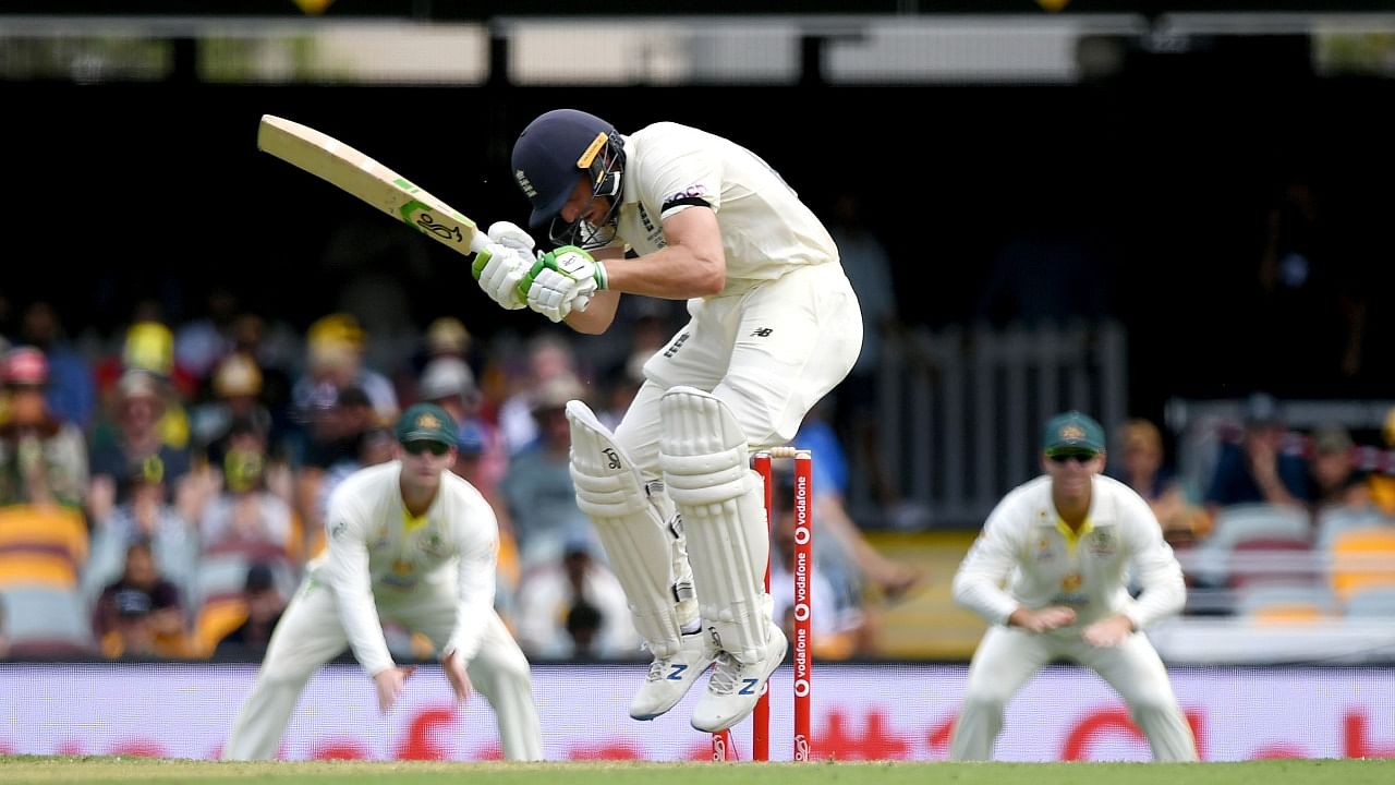 Jos Buttler ducks a bouncer on Day 1 of Ashes. Credit: Reuters Photo