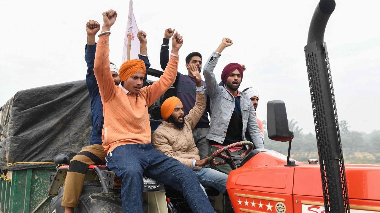 Farmers celebrate at the Singhu border in Delhi. Credit: AFP Photo