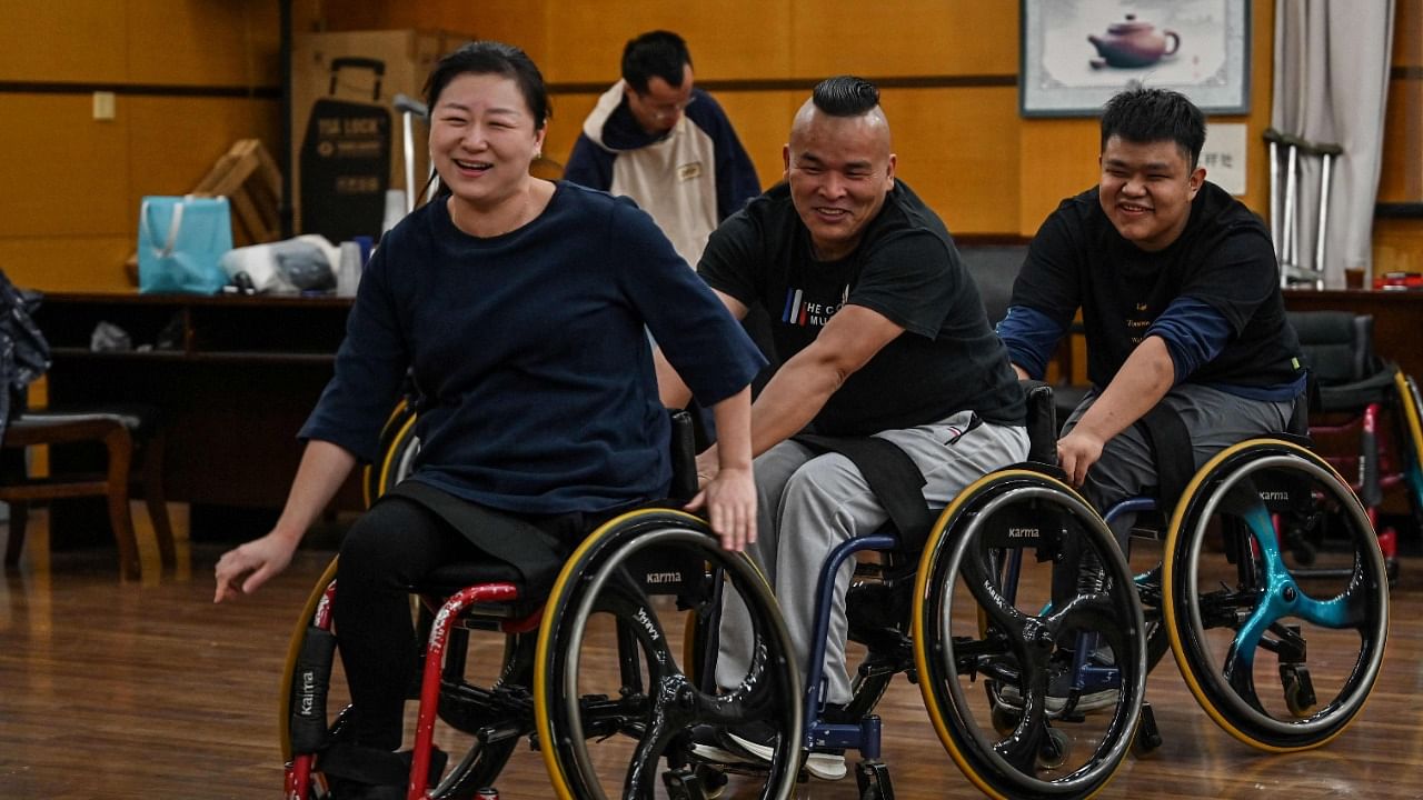 Wheelchair dancer Shao Yue (L) practices with the Shanghai Oriental Pearl TV Tower Handicapped Art Troupe on the outskirts of Shanghai. Credit: AFP Photo