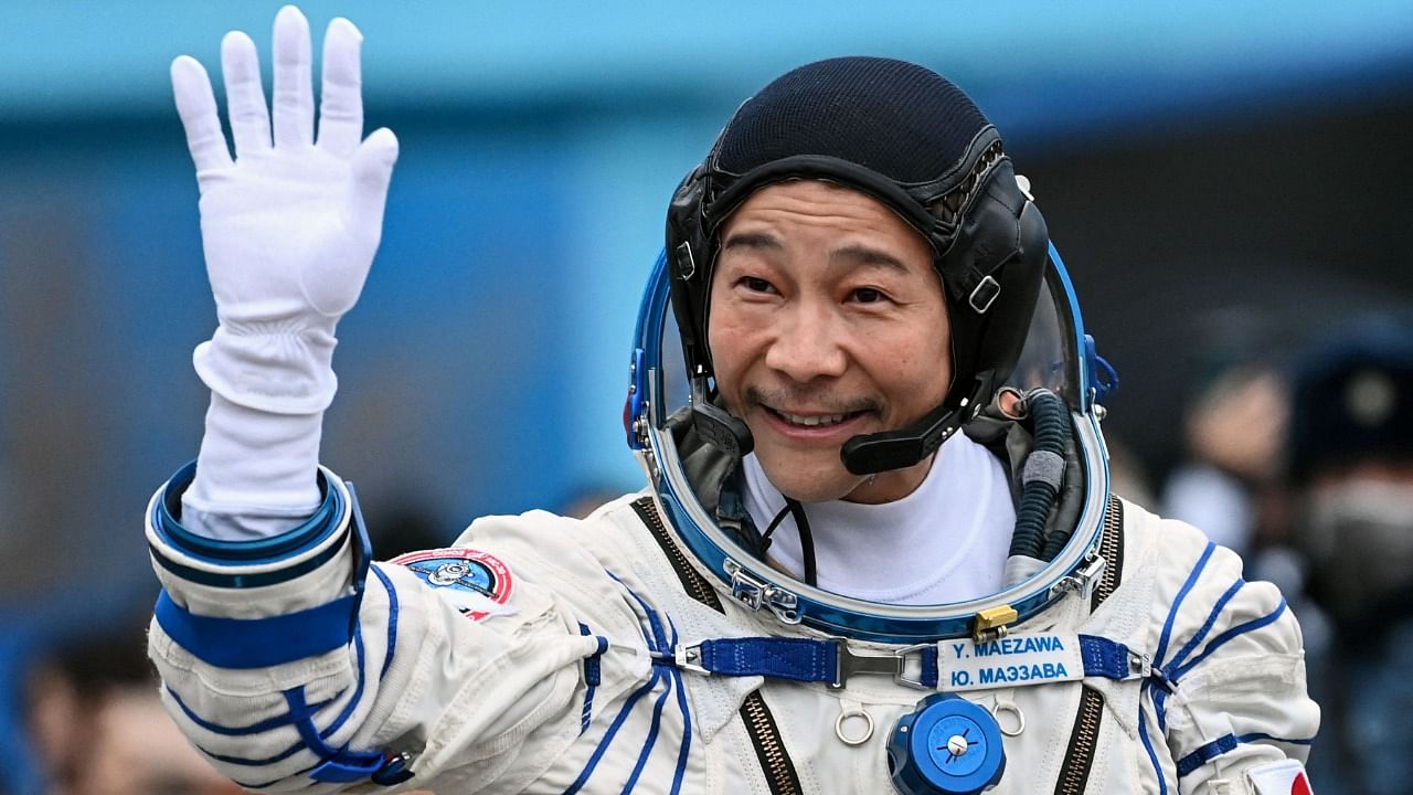 Japanese billionaire Yusaku Maezawa waves before boarding the Soyuz MS-20 spacecraft prior to the launch at the Baikonur cosmodrome on December 8, 2021. Credit: AFP Photo