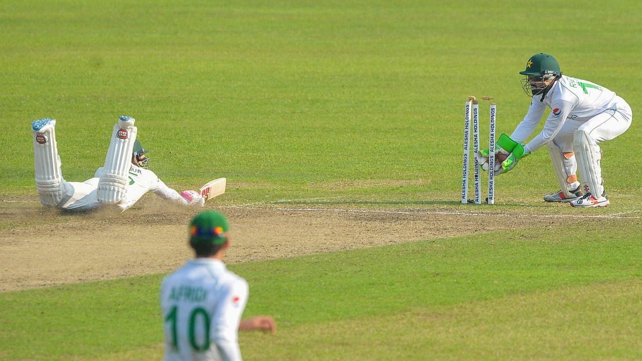 Pakistan's wicketkeeper Mohammad Rizwan (R) runs out Bangladesh's Mushfiqur Rahim. Credit: AFP Photo