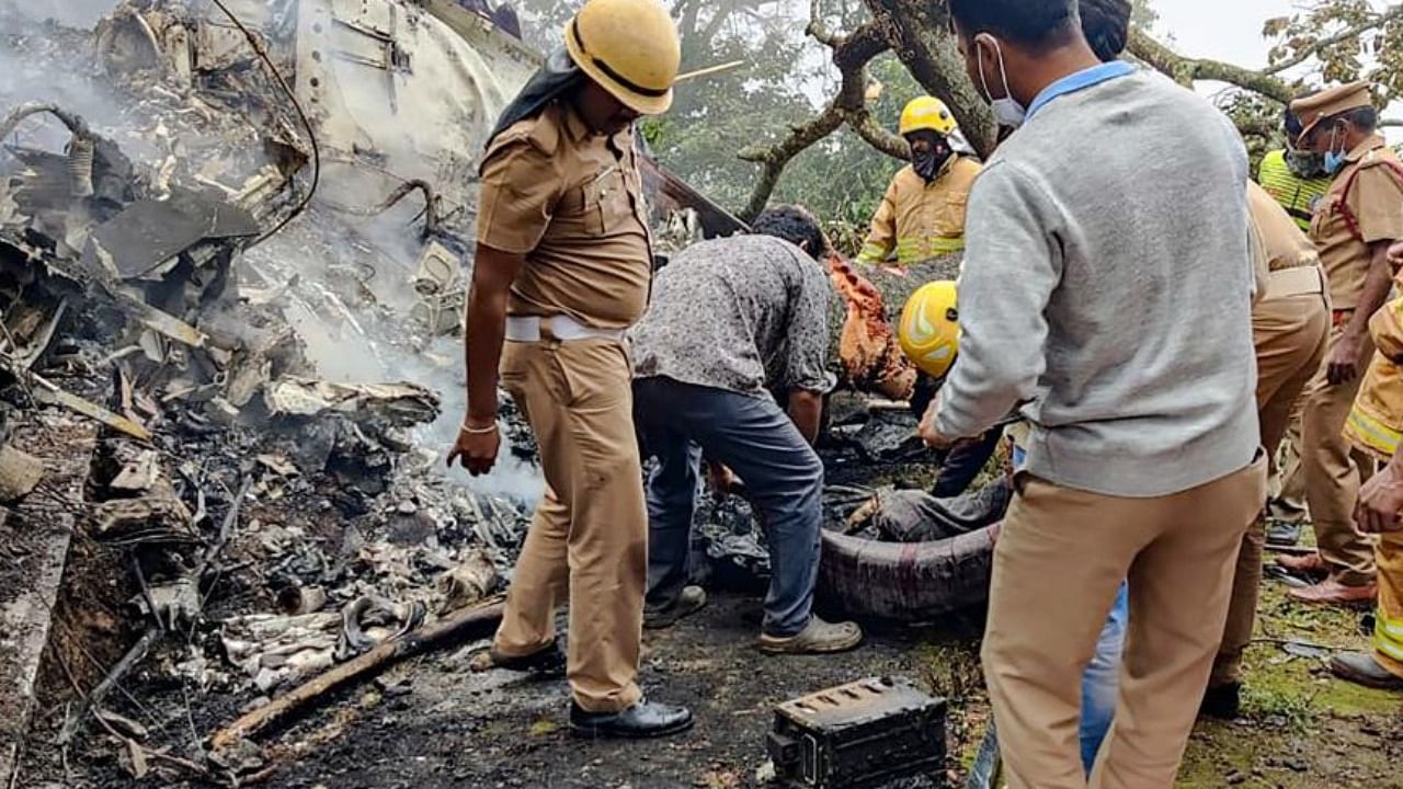  Rescue officals at the spot where an IAF Mi-17V5 helicopter crashed in Coonoor, Tamil Nadu, Wednesday, Dec. 8, 2021. CDS Gen Bipin Rawat, his staff and some family members were in the chopper. Credit: PTI Photo