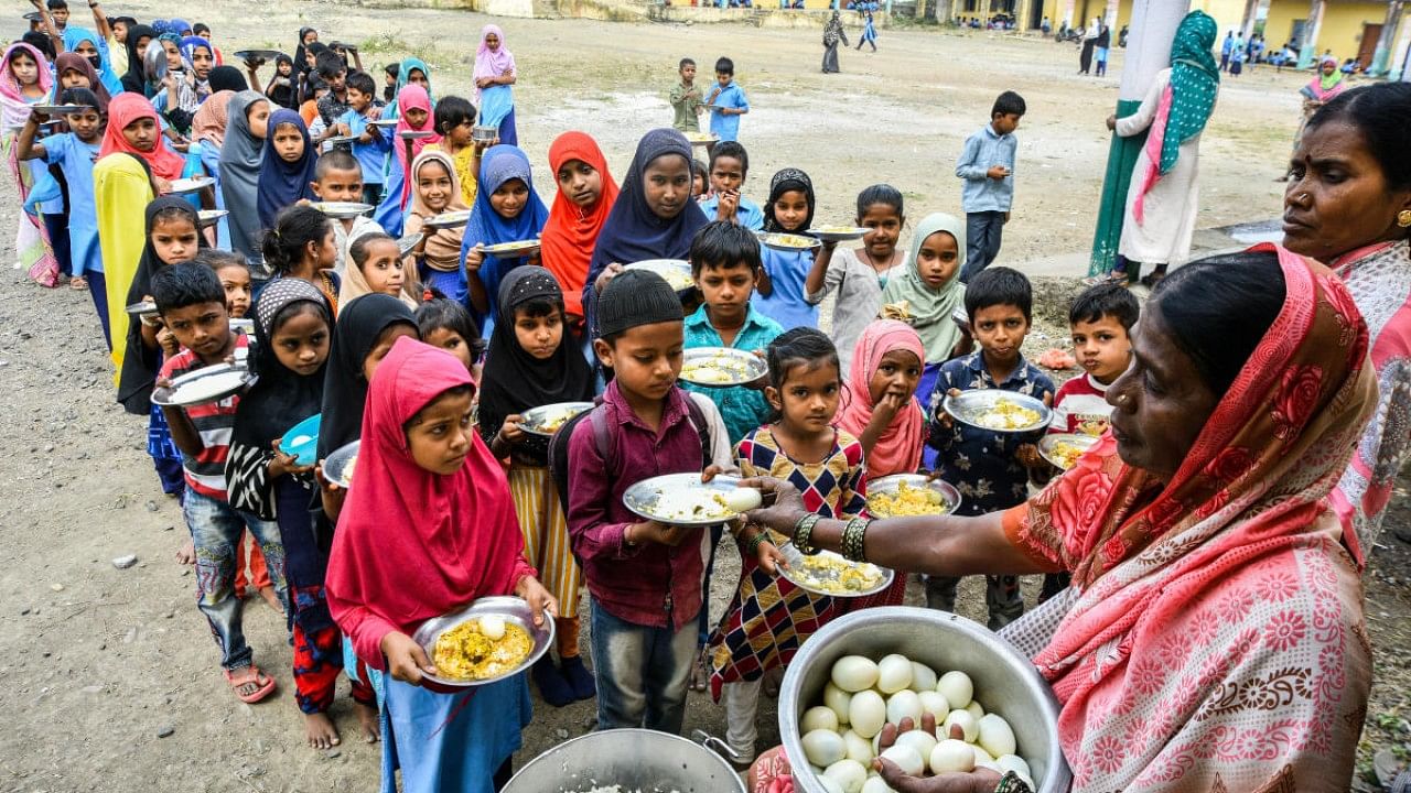 Children are served eggs along with midday meal at a government school in Jaffarbad of Kalaburagi taluk on Tuesday. Credit: DH Photo