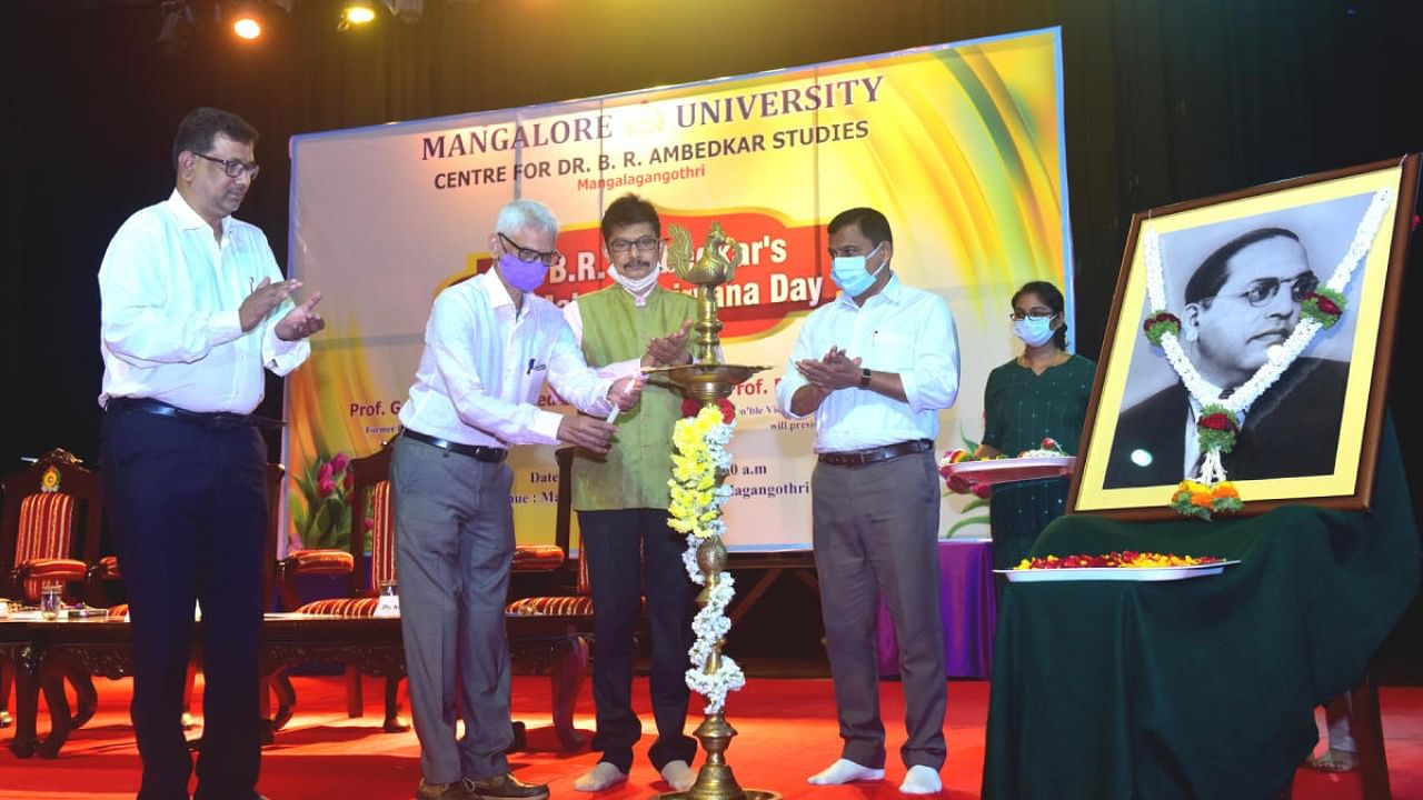 Govardhan Wankhede, former professor, Tata Institute of Social Sciences and Dean, School of Education, inaugurates Dr B R Ambedkar's 65th Mahaparinirvana Day at Mangalagangothri, Mangalore University. Credit: DH Photo