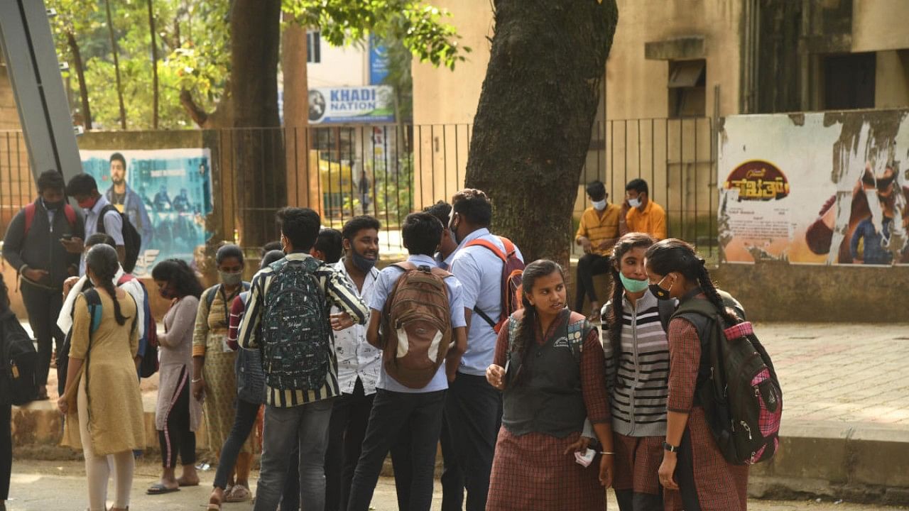 School and college students near a bus stop in Bengaluru on Wednesday. Credit: DH Photo