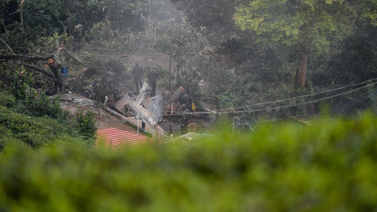 Army personnel carry out an investigation procedure at the crash site in Coonoor, Tamil Nadu, on December 9, 2021 a day after an army helicopter crashed, killing 13 people, including Indian defence chief General Bipin Rawat. Credit: AFP Photo