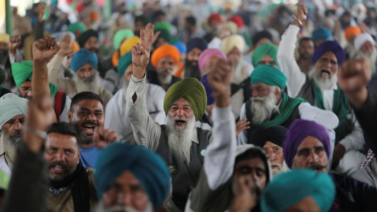 Farmers shout slogans as they attend ongoing speeches at the Singhu border protest site near the Delhi-Haryana border, India. Credit: Reuters Photo