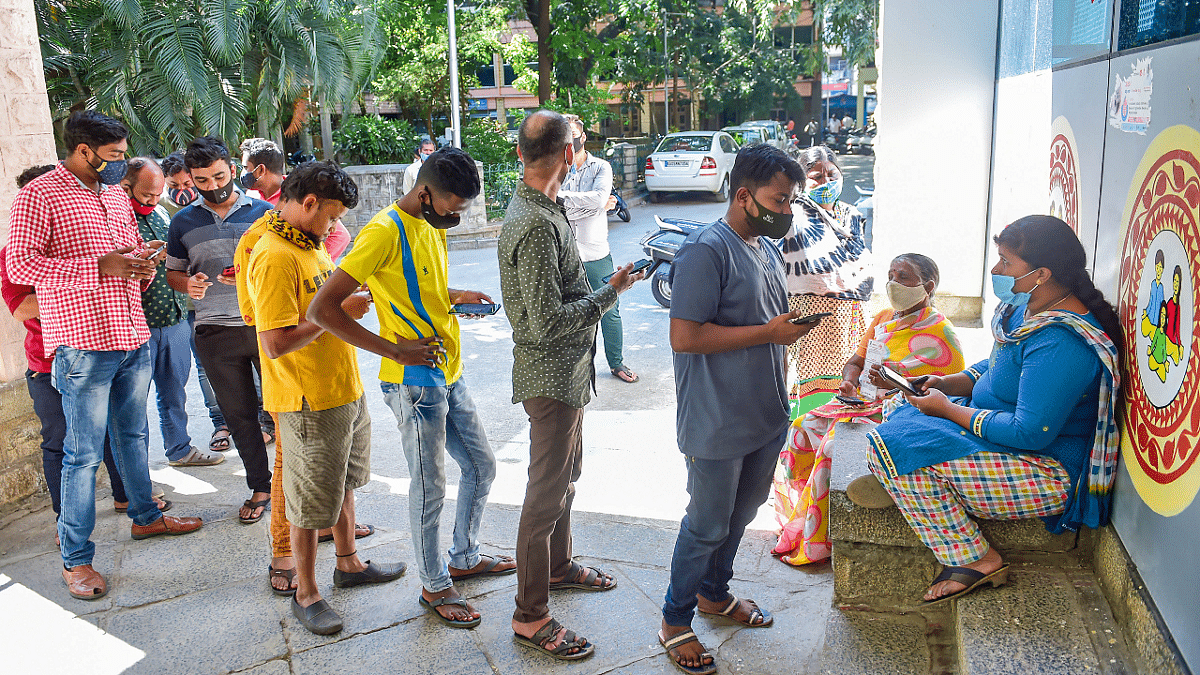 Beneficiaries wait to receive a dose of Covid-19 vaccine at a government hospital amid fear of spread of 'Omicron variant' in Bengaluru. Credit: PTI Photo