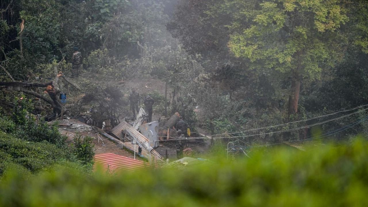 Army personnel carry out an investigation procedure at the crash site in Coonoor, Tamil Nadu, on December 9, 2021 a day after an army helicopter crashed, killing 13 people, including Indian defence chief General Bipin Rawat. Credit: AFP Photo