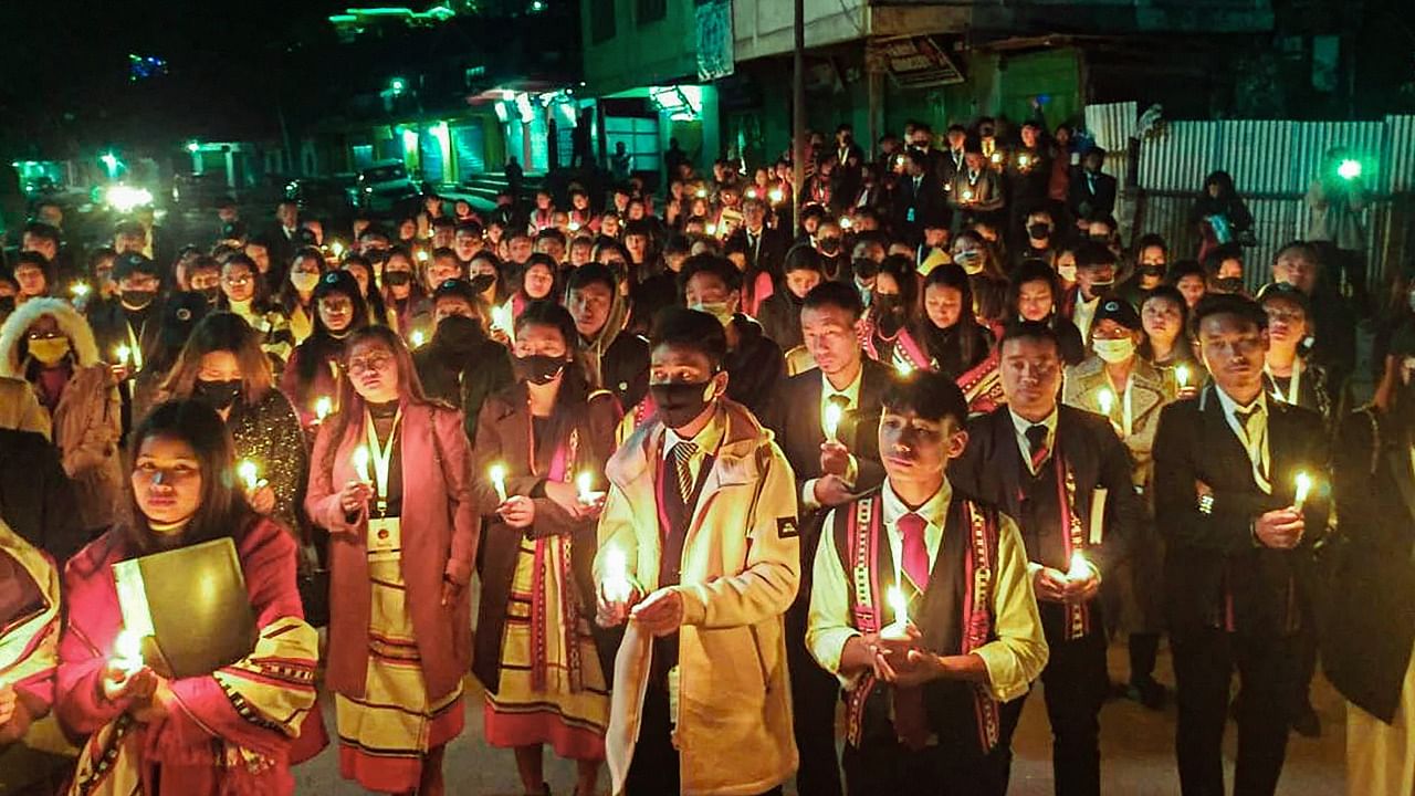 Locals participate in a candle march over the death of 13 people, who were killed by Armed Forces, in Mon. Credit: PTI Photo