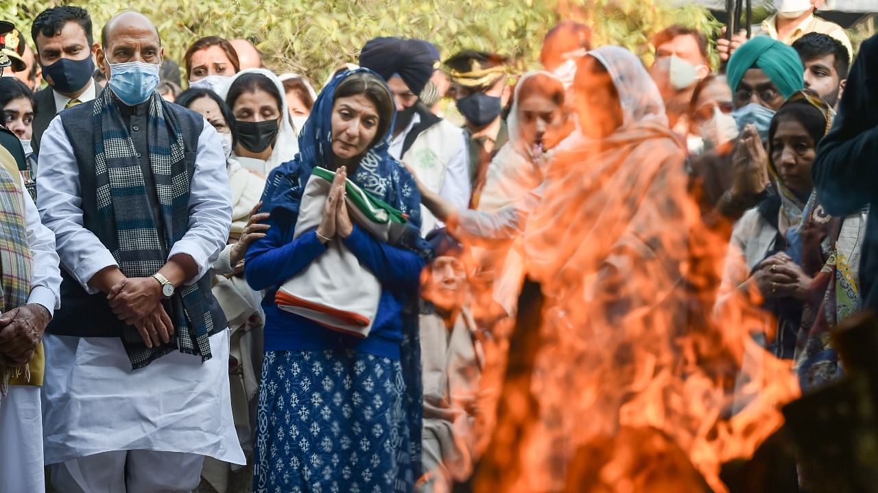 Defence Minister Rajnath Singh and wife and daughter of the late Brigadier LS Lidder during his cremation at Brar Square, Delhi Cantt, in New Delhi, Friday. Credit: PTI Photo