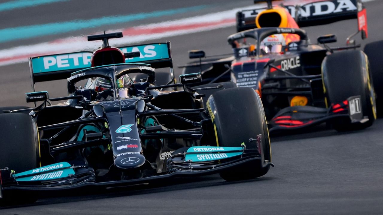 Mercedes' British driver Lewis Hamilton (L) drives ahead of Red Bull's Dutch driver Max Verstappen (R) at the Yas Marina Circuit. Credit: AFP Photo