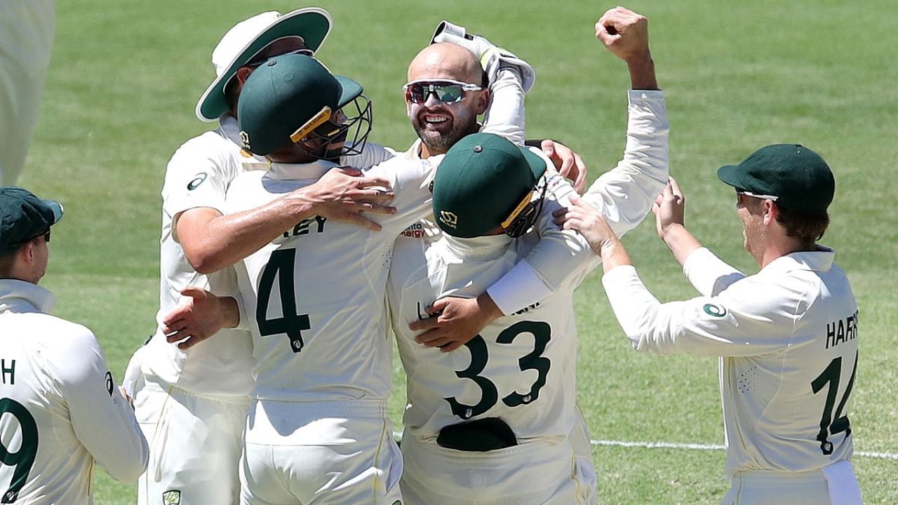 Australia's Nathan Lyon celebrates taking his 400th test wicket during day four of the First Ashes. Credit: Reuters Photo