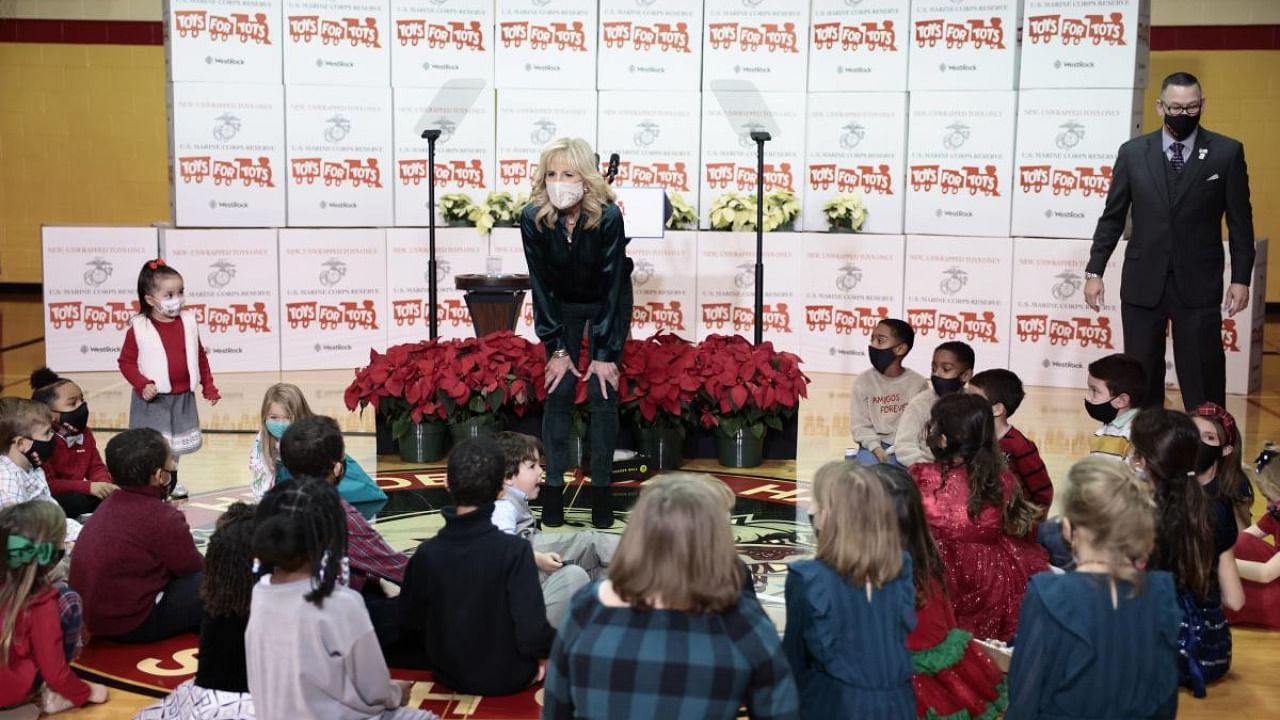 First Lady Dr. Jill Biden speaks with children of military members after participating in a sorting event for the annual Marine Toys for Tots Drive at the Joint Base Myer–Henderson Hall. Credit: AFP Photo
